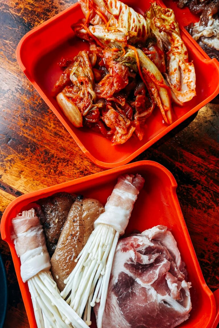 Delicious Korean BBQ ingredients and kimchi on a wooden table.